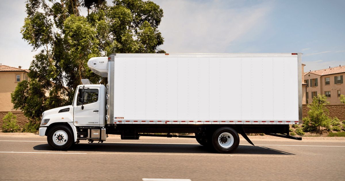 White 26ft box truck on the road for freight and delivery in Waxahachie, Texas